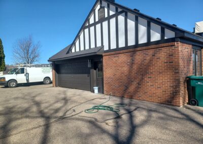 A white truck parked in front of a garage.